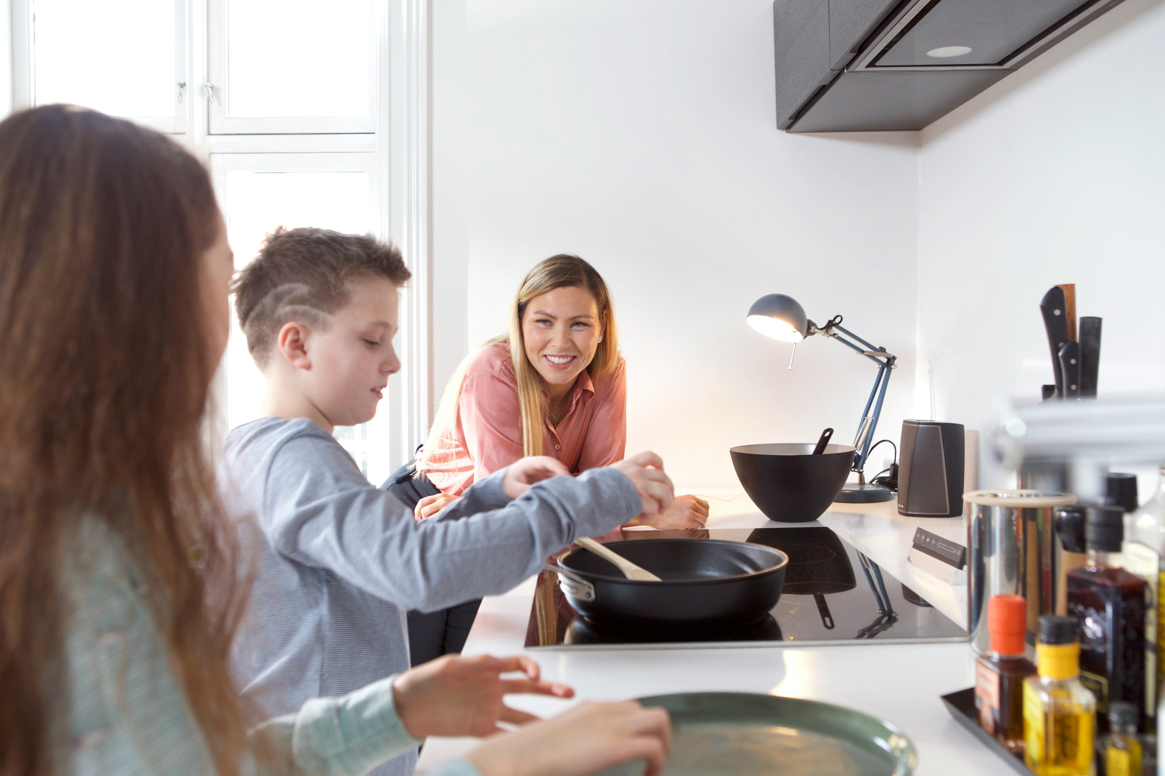 Family preparing food together with healthy safe cookware